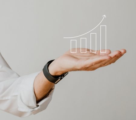 Digital increasing bar graph with businessman hand overlay